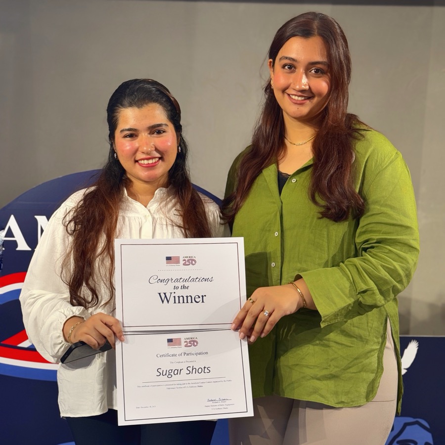 Two members of the Sugar Shots team holding a winner's certificate made out to Sugar Shots